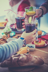 People with drinks while sitting at the dining table