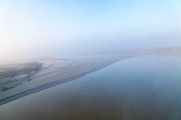 Foggy coast of Normandy in sunrise, light spectacle
