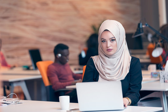 Young Arabic business woman wearing hijab,working in her startup office. Diversity, multiracial concept.