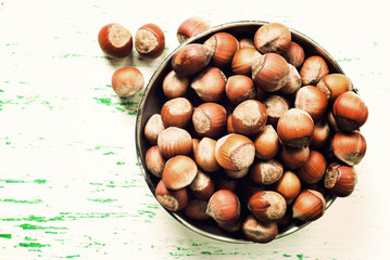 unshelled nuts in the old metal plate. Vintage style