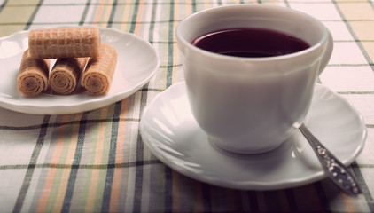 standing on the table white Cup with a tea of hibiscus. Vintage