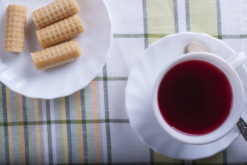Standing on the table white Cup of tea hibiscus. The view from the top