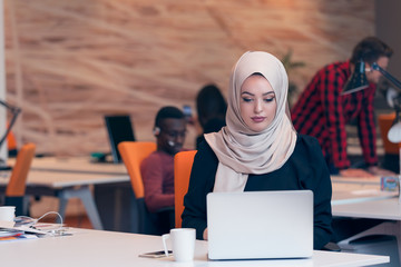 Young Arabic business woman wearing hijab,working in her startup office. Diversity, multiracial...