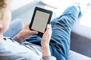 Man reading a book on digital device