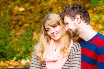 Fototapeta premium Lovers couple in autumn park on bench