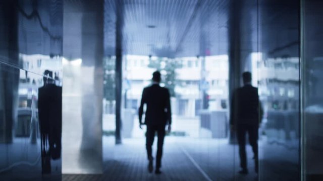 Businessman Walking on Streets of Business District outwards Camera. Shot on RED Cinema Camera in 4K (UHD).