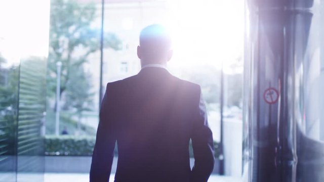 Follow Shot of Businessman Walking on Streets of Business District. Shot on RED Cinema Camera in 4K (UHD).