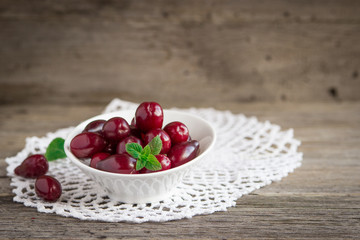 dogwood berries in  bowl on a rustic table