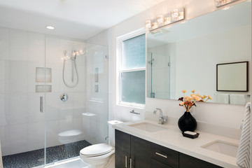 Fototapeta na wymiar Modern bathroom interior with glass door shower and white cabine