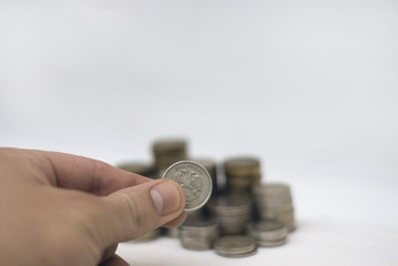 A stack of coins on a wooden background.