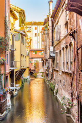 Fototapeta na wymiar water canal hidden behind a window in Italy
