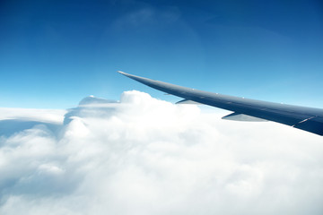 Wing of the plane on blue sky background