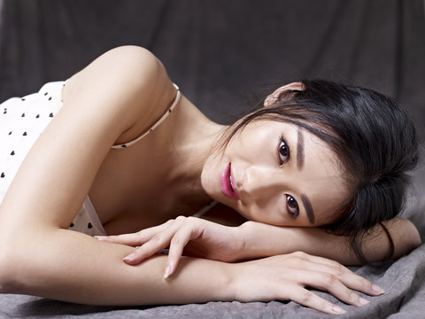 young asian woman lying on floor