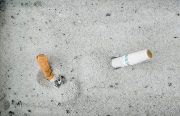 Smoked cigarettes in sand ashtray