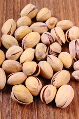 Pistachio nuts on wooden table, healthy eating