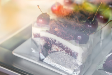Chocolate cake with red cherries .
