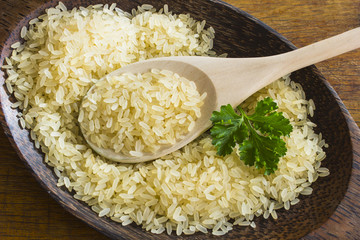 Rice on the plate with  wooden spoon