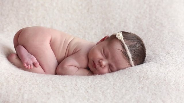 sleeping newborn baby in a wrap