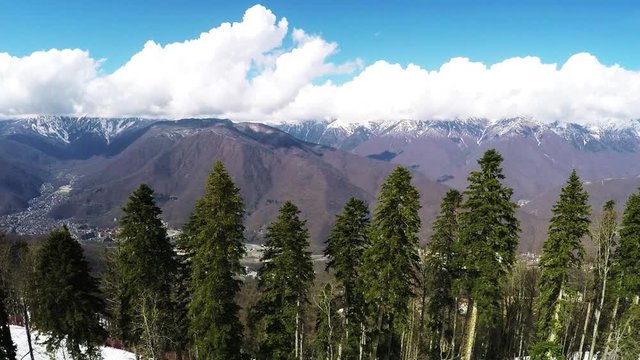 Quadrocopter shoot landscape of mountains. Sunny day. Nature. Snow. Trees Aerial view