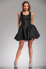 sexy blonde woman in black dress and high heels shoes