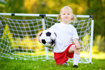 Cute little soccer player having fun playing a soccer game