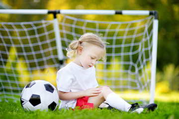 Cute little soccer player hurt her knee while defending a goal