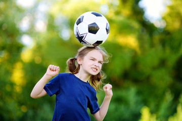 Cute little soccer player having fun playing a soccer game