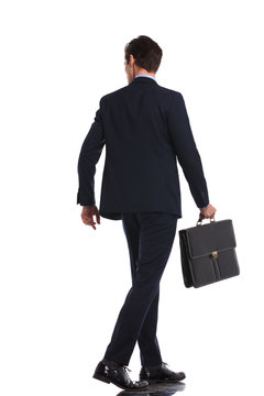 Back View Picture Of A Business Man Walking With Briefcase