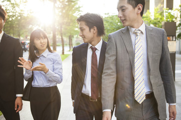 Young businessmen and women, while walking the business district
speaking