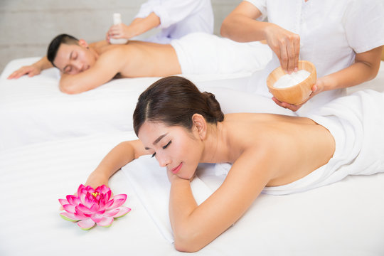 Young couple lying on the massage table and smiling