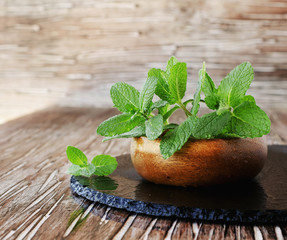 Fresh mint in a wooden bowl, selective focus