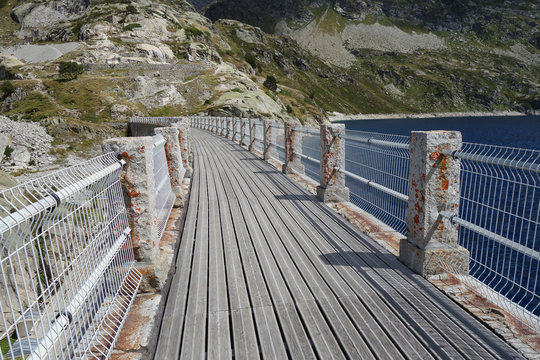 curved bridge over a dam in Artouste lake, French Pyrenees