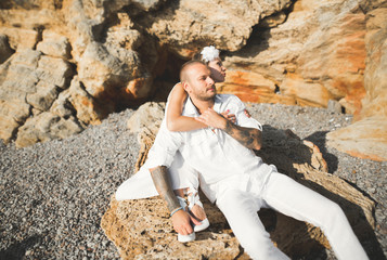 Fashion model couple with tattoo posing outside nea sea