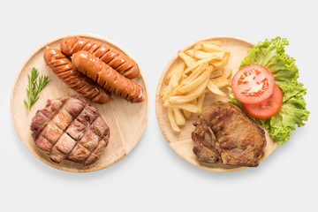 Grilled pork chop steak, sausage with french fries isolated.