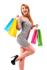 Young woman with shopping bags isolated on white