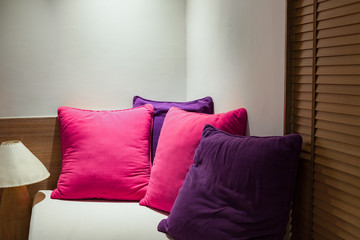 colorful pillows on corner of sofa in bedroom