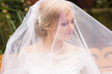 Fototapeta na wymiar face of a beautiful bride hidden veil