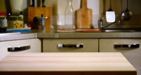 Wooden table on blurred background of kitchen