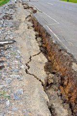 collapsed and cracked asphalt road after flood