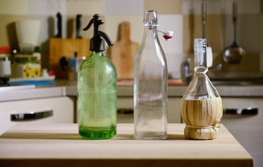 bottles on wooden table on kitchen  background