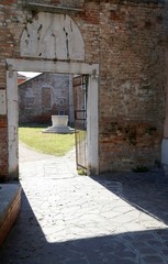 gate with a well in the courtyard on the island of Murano near V