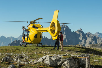 Yellow helicopter used for rescue operations, On the ground in Dolomites, Italy. Helicopter rescue