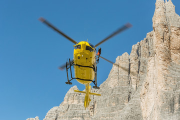 Yellow helicopter used for rescue operations, On the ground in Dolomites, Italy. Helicopter rescue