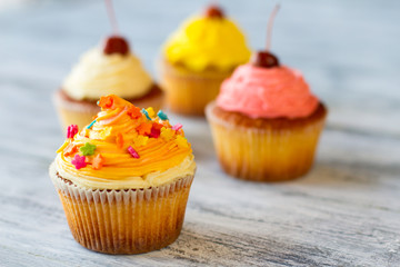 Cupcake with decoration. Cream of orange color. Appetizing and fresh sweets. Yummy for your tummy.