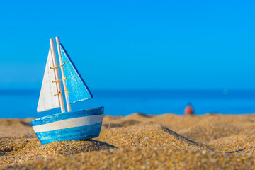 toy sailboat on the beach