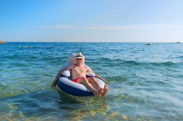 Senior man floating in sea