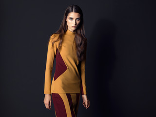 Fashion model wearing elegant suit posing on black background