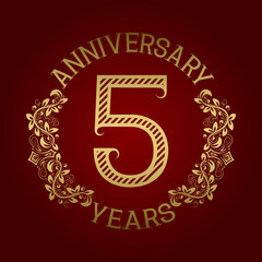 Golden emblem of fifth anniversary. Celebration patterned sign on red.