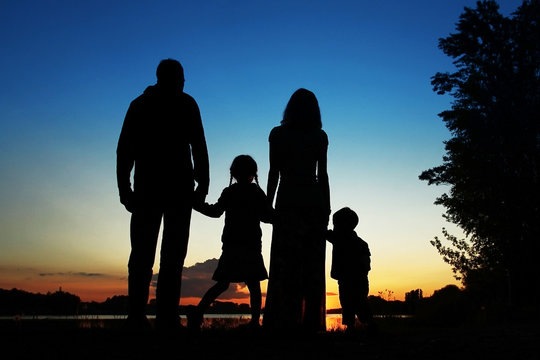 silhouette family, including his father, mother and two children