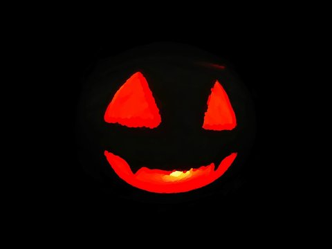 Halloween burning pumpkin face on dark background